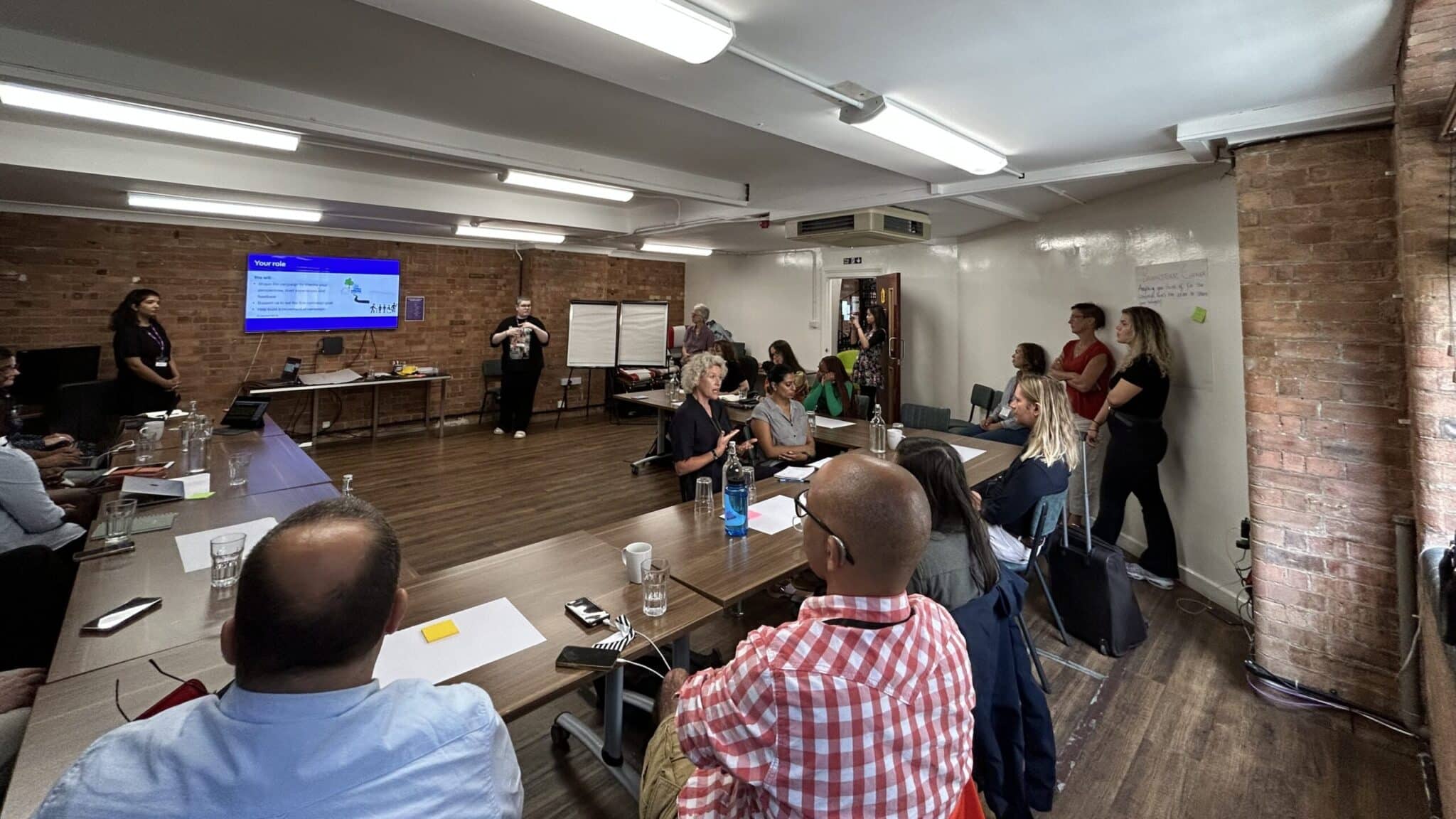 Group of people watching a presentation