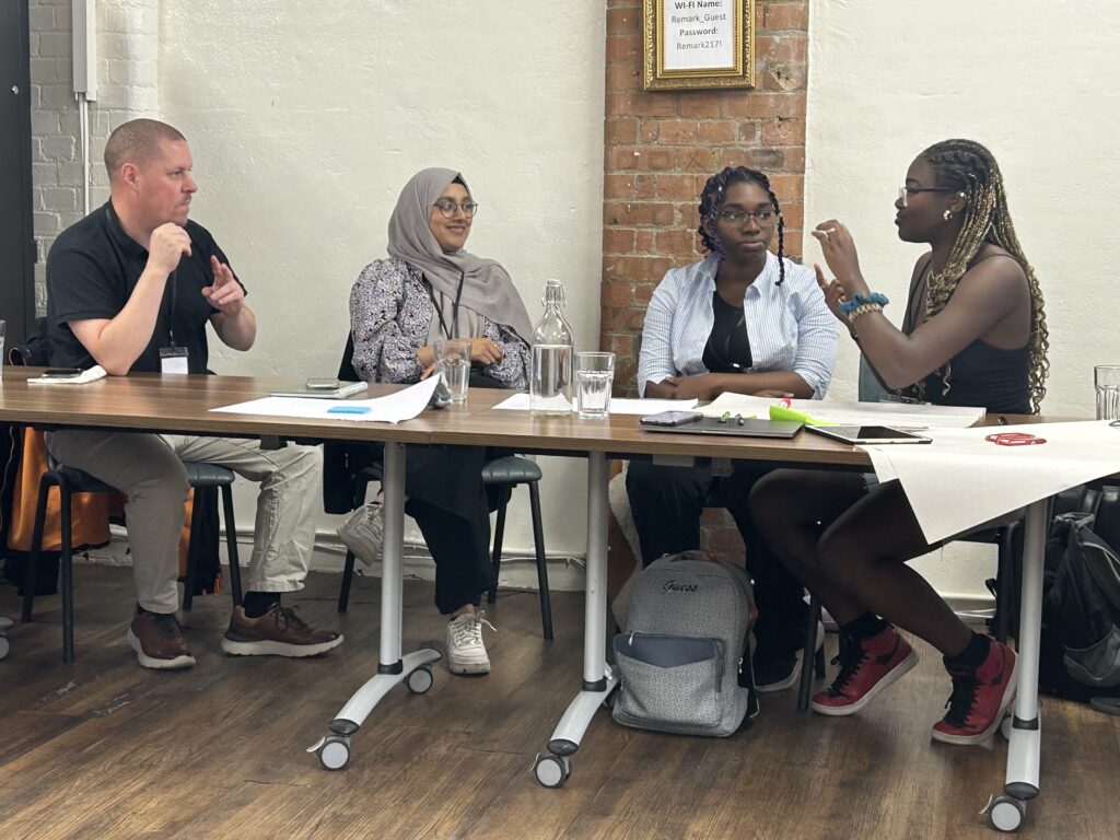 Four people at a table discussing in sign language